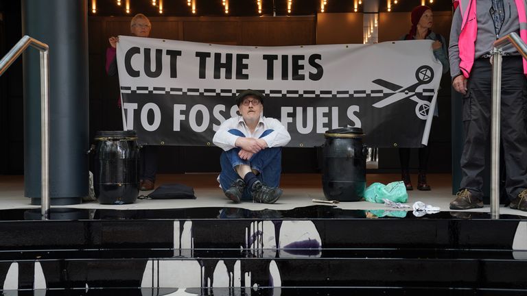 Extinction Rebellion activists protest at Labour Party&#39;s London headquarters in London, after pouring a pool of fake oil over the steps and letting off smoke grenades. Picture date: Monday September 18, 2023.