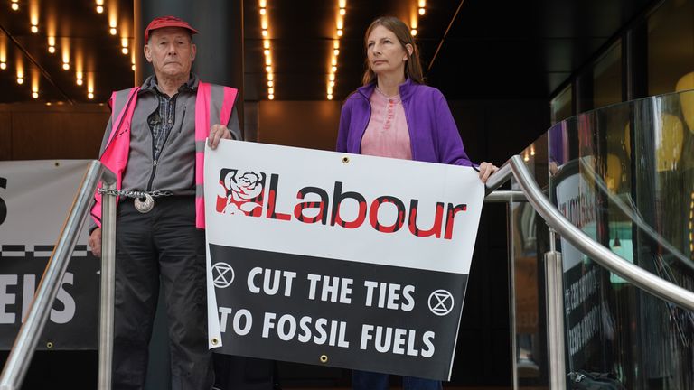 Extinction Rebellion activists protest at Labour Party&#39;s headquarters in London, after pouring fake oil over the steps and letting off smoke grenades. Picture date: Monday September 18, 2023.