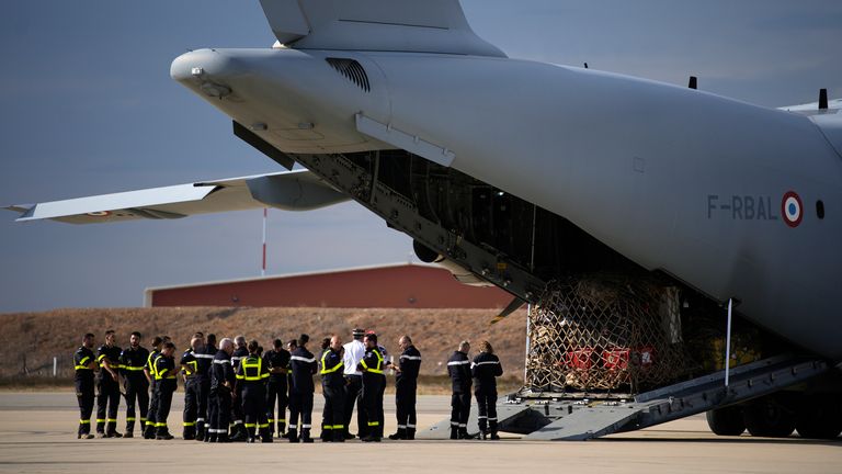 French aid workers wait by a cargo plane loaded with disaster relief for Libya at the Istres military base, southern France
Pic:AP