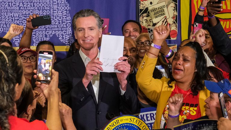 Fast food workers cheered and cried as California Governor Gavin Newsom signed the bill. Pic: AP