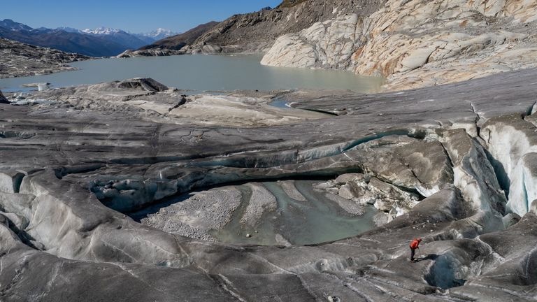 Andreas Bauer of the Laboratory of Hydraulics, Hydrology and Glaciology of the ETHZ works near a collapsed part of the Rhone glacier, amid climate change, in Obergoms, Switzerland, September 26, 2023. REUTERS/Denis Balibouse
