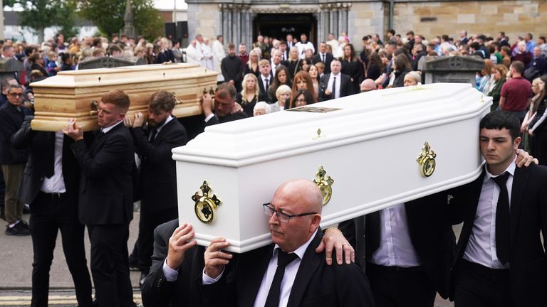 Paul McSweeney (right) carries the coffins of his children Luke, 24 and Grace McSweeney, 18, following their funeral at Saints Peter and Paul&#39;s Church, Clonmel, Co Tipperary 