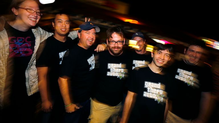 Computer game animator Michael Petterson (C) and his fellow developers gather for a picture as they attend the midnight release of their game "Grand Theft Auto Five" at a local Game Stop store in Encinitas, California September 17, 2013. The launch comes at a time when the $66 billion video game industry, which has been struggling with flagging sales, is expecting a shot in the arm from holiday game releases and new game hardware like Sony&#39;s PlayStation 4 and Microsoft&#39;s Xbox One. REUTERS/Mike 