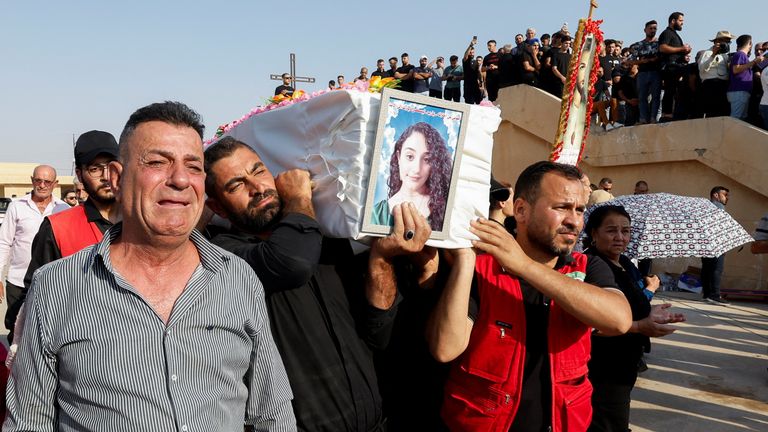 Mourners carry a coffin of a victim of the fatal fire of a wedding celebration, during the funeral in Hamdaniya, Iraq, September 27, 2023. REUTERS/Khalid Al-Mousily
