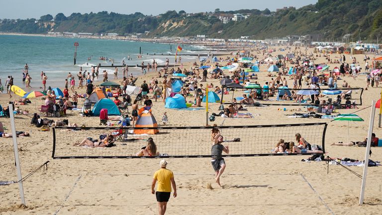 People enjoying the sun on Bournemouth beach,  Dorset