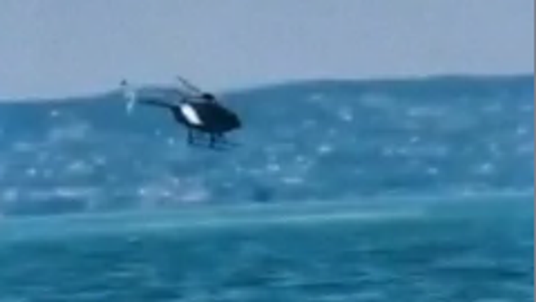 Moment a police helicopter crashed into a lake in Hungary.