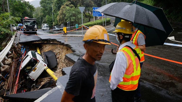 A vehicle is seen at a collapsed road section after flood and heavy rains in Hong Kong