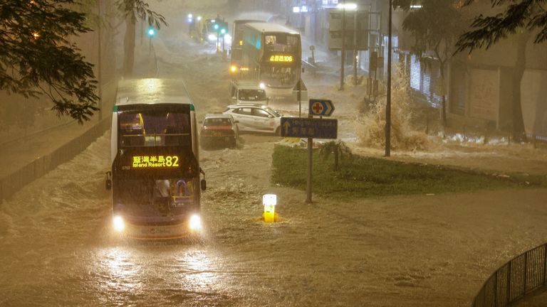 A bus drives past a flooded area