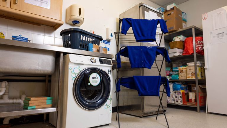 Pupils use the laundry facilities at St. Cuthbert&#39;s Catholic Academy in Blackpool