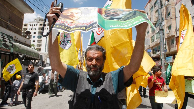 A protester calls for the release of Palestinian prisoners held in Israeli jails in the West Bank