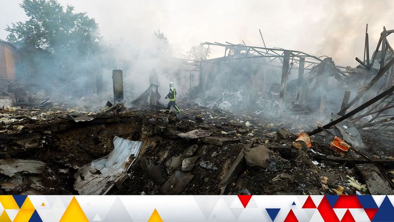 A firefighter works at a site in a residential area, damaged during a Russian missile strike