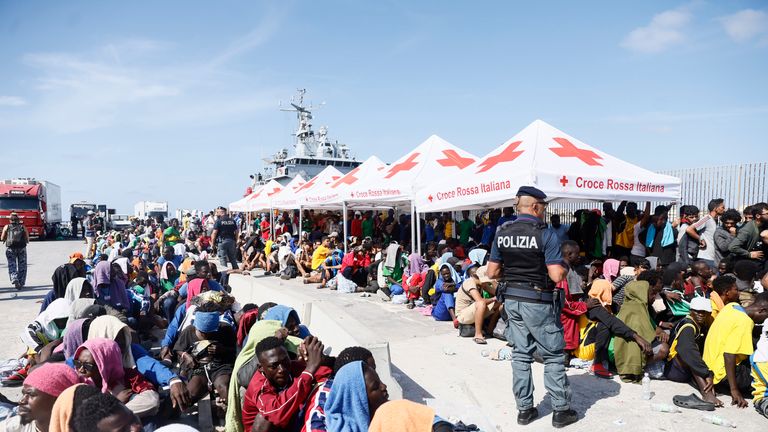 Migrants wait to be transferred from the Lampedusa Island to the mainland, Friday, Sept. 15, 2023. Thousands of migrants and refugees have landed on the Italian island of Lampedusa this week after crossing the Mediterranean Sea on small unseaworthy boats from Tunisia, overwhelming local authorities and aid organizations .(Cecilia Fabiano/LaPresse via AP)