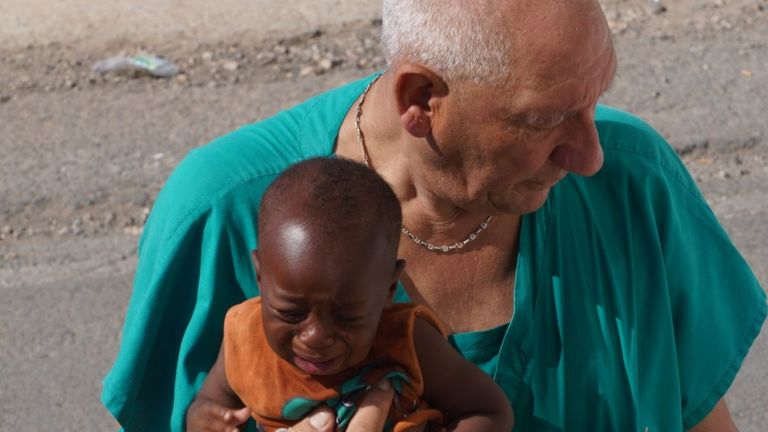 A medic with a baby on Lampedusa