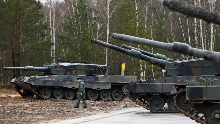 A Polish soldier walks next to the Leopard 2 tanks during a training at a military base and test range in Swietoszow, Poland, Monday, Feb. 13, 2023. The training is part of the European Union&#39;s military assistance to Ukraine. (AP Photo/Michal Dyjuk)