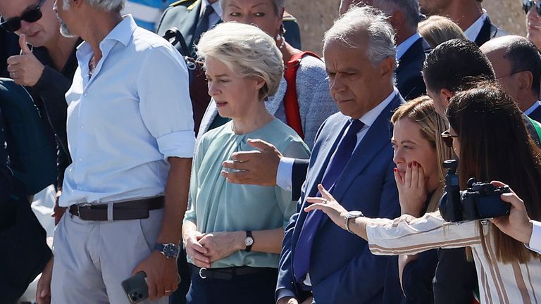 The President of the European Commission, Ursula von der Leyen, fifth from right front row, and the Italy&#39;s Premier Giorgia Meloni, third from right front row, visit the island of Lampedusa, in Italy, Sunday, Sept. 17, 2023. EU Commission President Ursula von der Leyen and Italian Premier Giorgia Meloni on Sunday toured a migrant center on Italy...s southernmost island of Lampedusa that was overwhelmed with nearly 7,000 arrivals in a 24-hour period this week. (Cecilia Fabiano/LaPresse via AP)