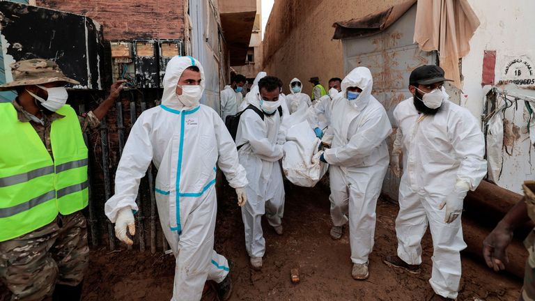 Volunteers carry a dead body they found under the rubble of a building after a deadly storm and flooding hit Libya, in Derna, Libya September 17, 2023. REUTERS/Zohra Bensemra