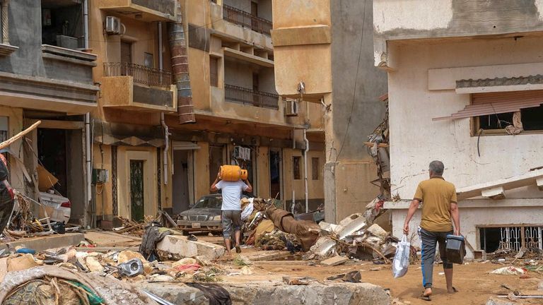 People walk between the debris, after a powerful storm and heavy rainfall hit Libya, in Derna, Libya September 12, 2023. REUTERS/Esam Omran Al-Fetori BEST QUALITY AVAILABLE
