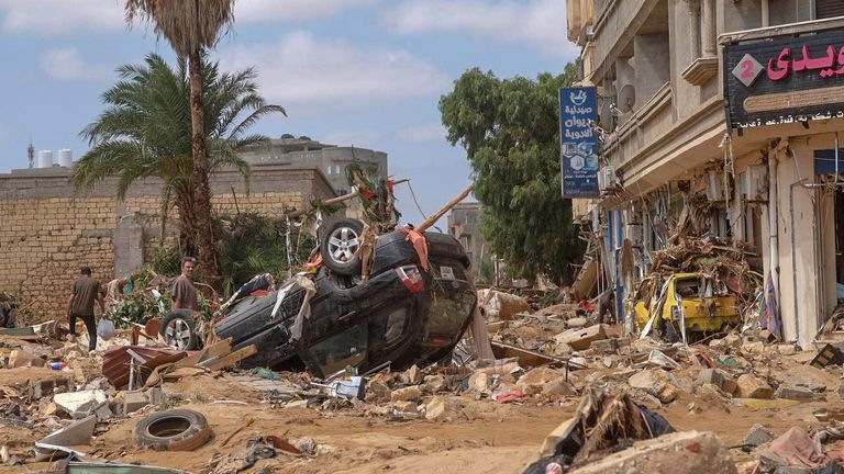 A man stands next to a damaged car, after a powerful storm and heavy rainfall hit Libya, in Derna, Libya September 12, 2023. REUTERS/Esam Omran Al-Fetori BEST QUALITY AVAILABLE
