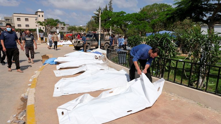 Body bags are lined up on a street in Derna, Libya
