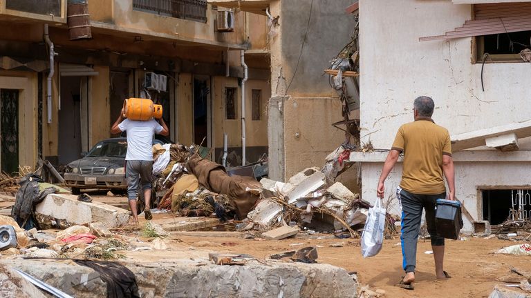 People walk between the debris, after a powerful storm and heavy rainfall hit Libya, in Derna, Libya September 12, 2023. REUTERS/Esam Omran Al-Fetori REFILE - QUALITY REPEAT
