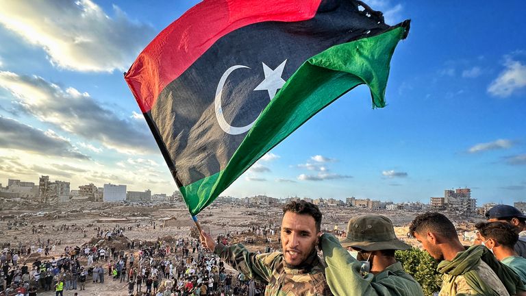A protester waves the Libyan flag