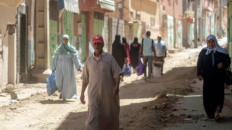 People walk and carry some of their possessions as they leave their town which was damaged by the earthquake, in Amizmiz, near Marrakech, Morocco, Sunday, Sept. 10, 2023. Towns and villages throughout Morocco&#39;s Atlas Mountains are mourning the dead and seeking aid after a record earthquake wreaked destruction throughout the region last week. (AP Photo/Mosa&#39;ab Elshamy)