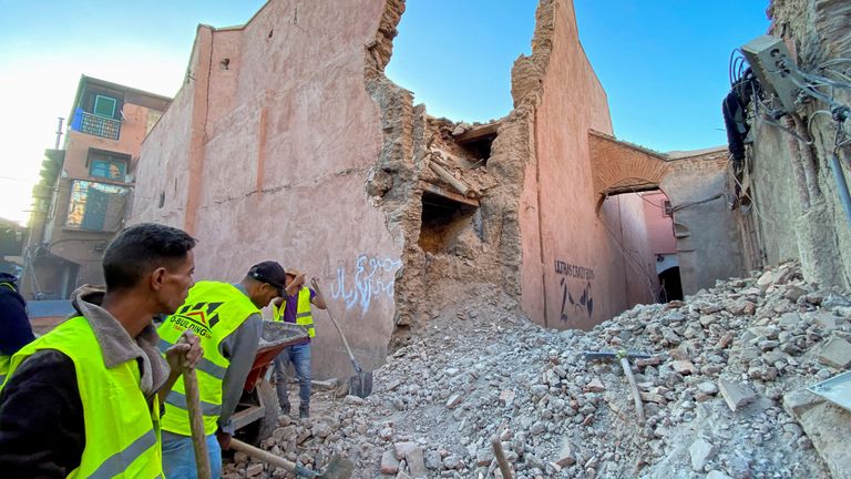People work next to damage in the historic city of Marrakech, following a powerful earthquake in Morocco, September 9, 2023. REUTERS/Abdelhak Balhaki