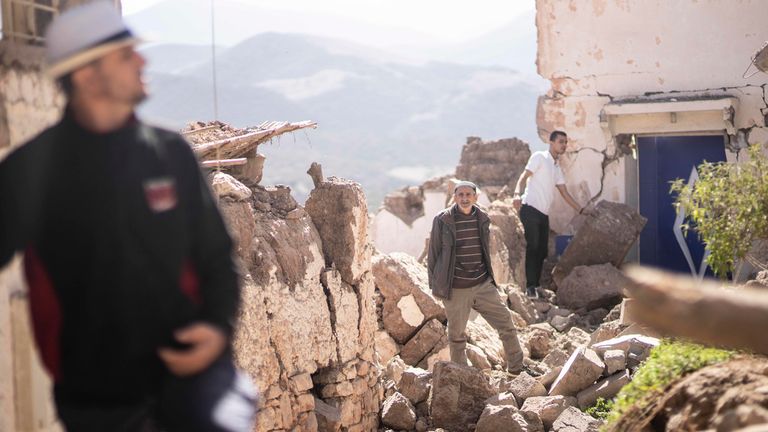 People inspect their damaged homes after an earthquake in Moulay Brahim village. Pic: AP