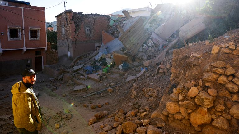 A man stands next to damaged buildings and debris, in the aftermath of a deadly earthquake in Moulay Brahim, Morocco, September 10, 2023. REUTERS/Hannah McKay TPX IMAGES OF THE DAY