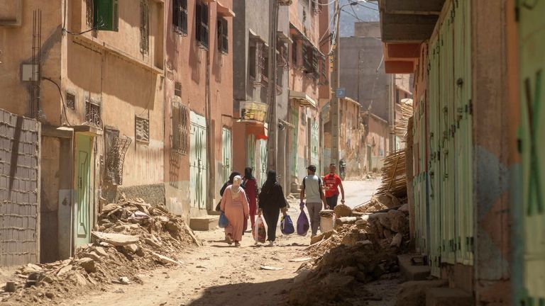 People carry some of their possessions as they leave their town which was damaged by the earthquake, in Amizmiz, near Marrakech, Morocco, Sunday, Sept. 10, 2023. An aftershock rattled Moroccans on Sunday as they mourned victims of the nation...s strongest earthquake in more than a century and sought to rescue survivors while soldiers and aid workers raced to reach ruined mountain villages. (AP Photo/Mosa&#39;ab Elshamy)