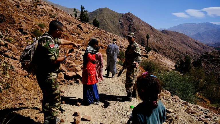 A father who lost two children walks with his surviving family to safety