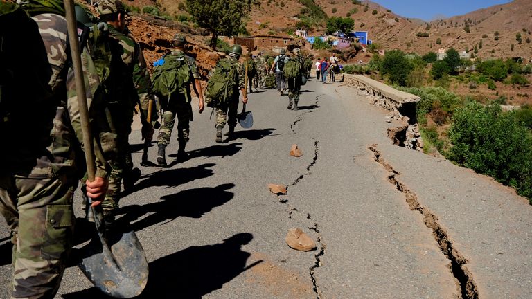 Army soldiers hike up the mountains