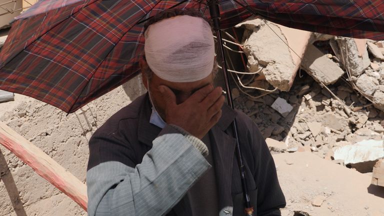 A man fights back tears following the earthquake