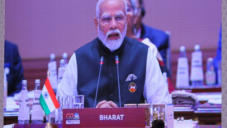 A giant screen displays India&#39;s Prime Minister Narendra Modi at the International Media Centre, as he sits behind the country tag that reads "Bharat", while delivering the opening speech during the G20 summit in New Delhi, India, September 9, 2023. REUTERS/Anushree Fadnavis
