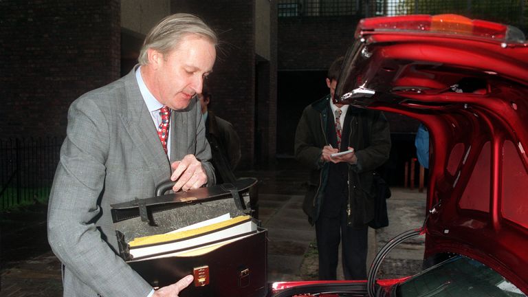 Trade Minister Neil Hamilton MP prepares to leave for a ministerial meeting in Sussex.
