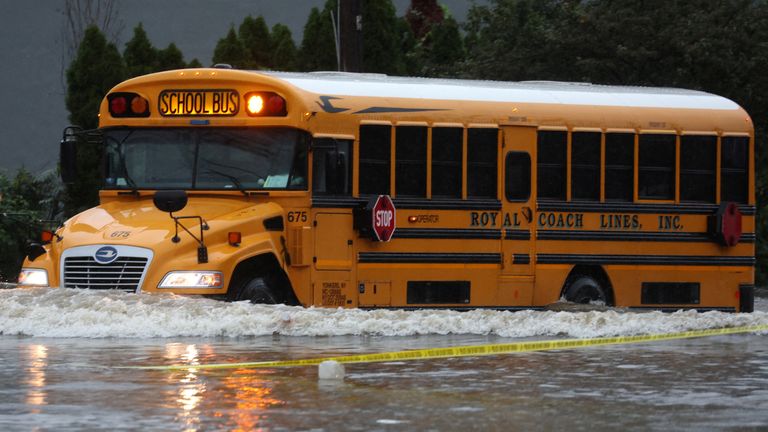 A school bus drives through heavy flooding in the New York City suburb of Larchmont

