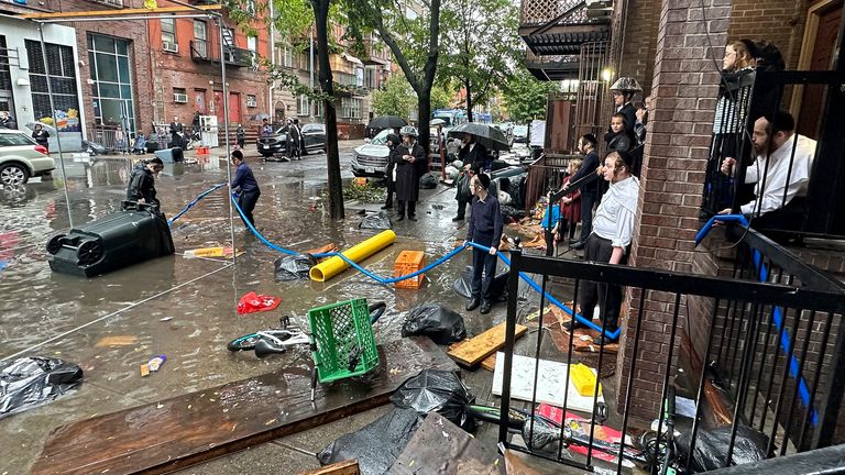 Workers trying to clear in Brooklyn. Pic: AP