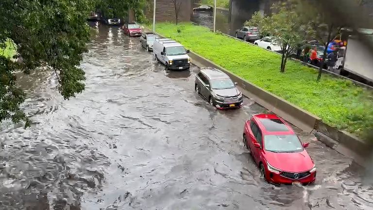 In this photo taken from video, traffic makes its way through flood waters along the Brooklyn Queens Expressway , Friday, Sept. 29, 2023