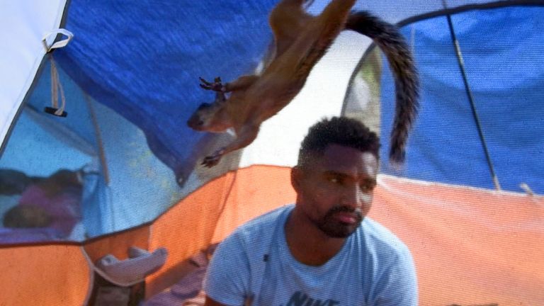 Niko, a pet squirrel, is fed by his owner, Yeison, in their tent at a migrant camp in Matamoros, Mexico. The pair travelled thousands of miles to the US border, but now may be separated if he is granted entrance to the US. Pic: AP/Valerie Gonzalez