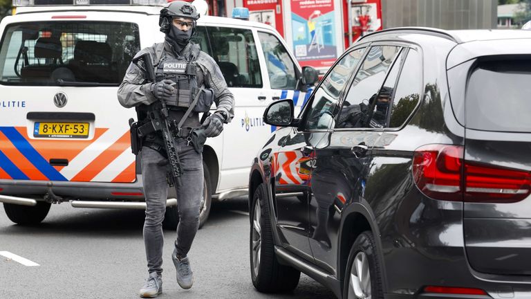 A police officer from the special intervention service walks outside the Erasmus MC Rotterdam hospital on Rochussenstraat, which has been cordoned off after two shooting incidents in Rotterdam