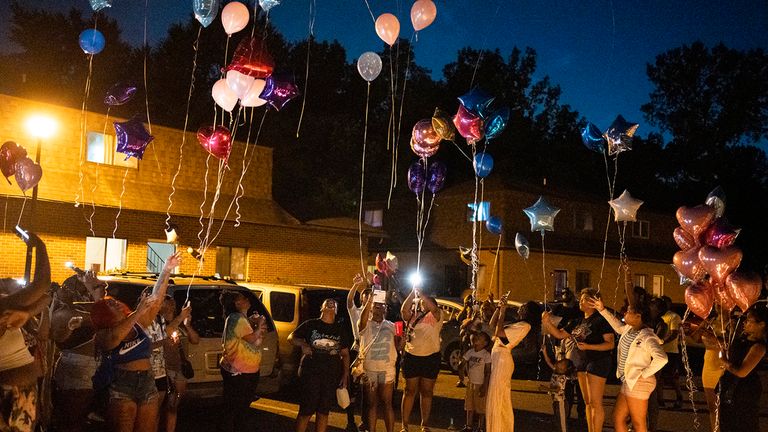 Family and friends release balloons at a private vigil. Pic; AP