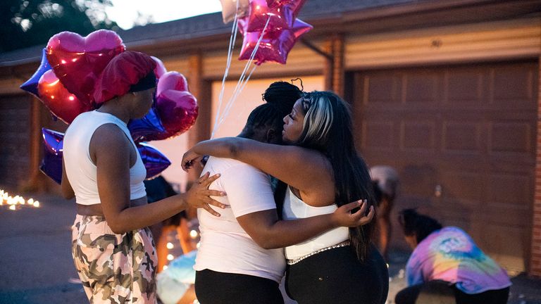 Friends comfort each other at a private candlelight vigil. Pic: AP