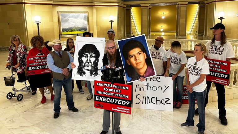 The Rev. Jeff Hood and supporters of Oklahoma death row inmate Anthony Sanchez proclaim his innocence during a news conference at the Oklahoma Capitol in Oklahoma City, May 25, 2023. Sanchez said Thursday, June 22, in a phone interview from death row that he plans to reject his opportunity for a clemency hearing in the case. (AP Photo/Sean Murphy)