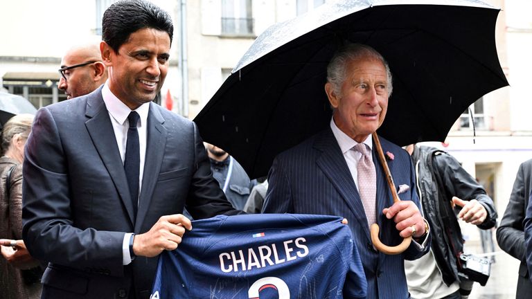 Paris Saint Germain&#39;s president Nasser al-Khelaifi presents  King Charles with a Paris Saint Germain football shirt during a visit to Saint-Denis 