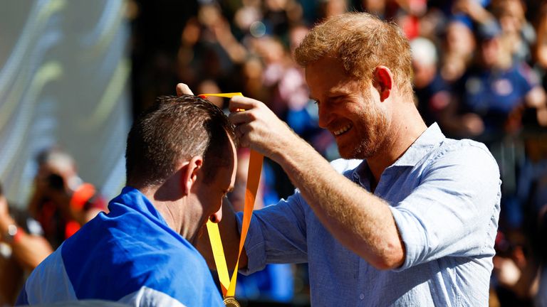 The Duke of Sussex presents medal to a cyclist