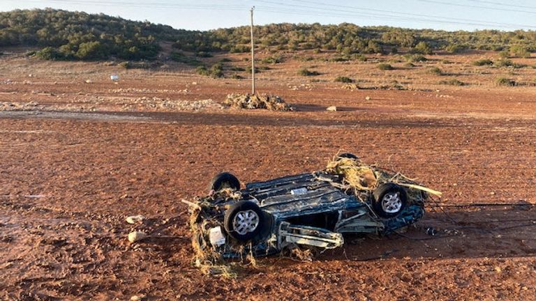 A damaged car after heavy rainfall hit Qandula in Libya