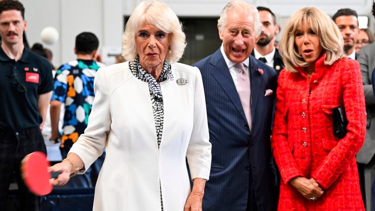 Queen Camilla plays table tennis as King Charles and  Brigitte Macron look on during visit to a gymnasium,  in Saint-Denis
Pic:AP