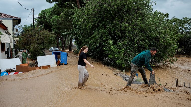 Locals try to protect their house from floodwater after torrential rains destroyed the infrastructure and caused flooding, in Agria, Greece September 6, 2023. REUTERS/Louisa Gouliamaki