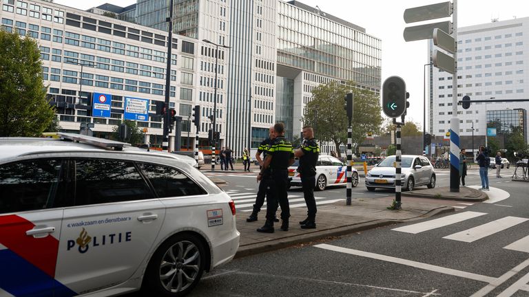 Police officers secure the area after Dutch police arrested a suspect after a shooting in Rotterdam, Netherlands