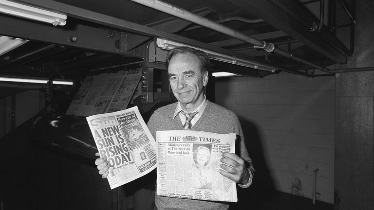 Newspaper proprietor Rupert Murdoch holds copies of The Sun and Times papers, at his new high technology print works in Wapping, East London.